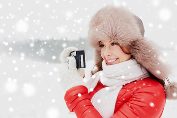 Image showing happy woman with film camera outdoors in winter