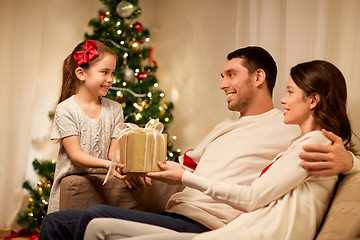 Image showing happy family with christmas present at home