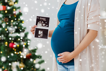 Image showing pregnant woman with ultrasound images at christmas