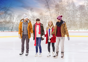 Image showing happy friends on outdoor skating rink