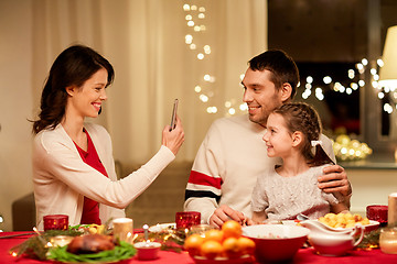 Image showing happy family taking picture at christmas dinner