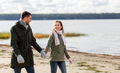 Image showing couple walking along autumn beach