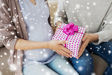 Image showing close up of man giving present to pregnant wife