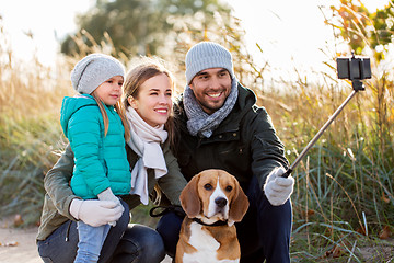 Image showing happy family with dog taking selfie in autumn