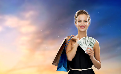 Image showing smiling woman in dress with shopping bags