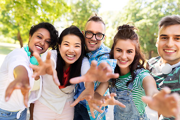 Image showing happy smiling friends having fun in park