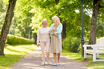 Image showing daughter with senior mother walking at summer park