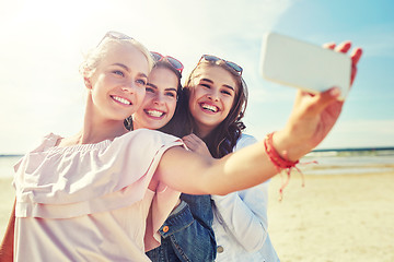 Image showing group of smiling women taking selfie on beach