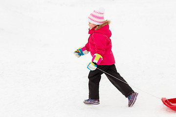 Image showing little girl with sleds on snow hill in winter