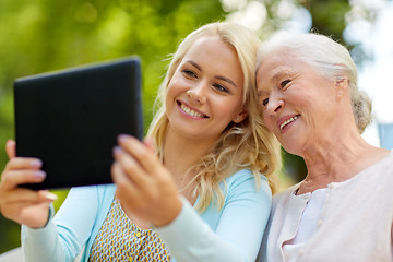 Image showing daughter with tablet pc and senior mother at park