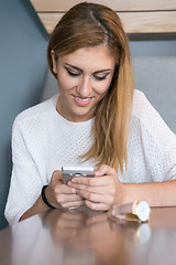 Image showing young woman using mobile phone