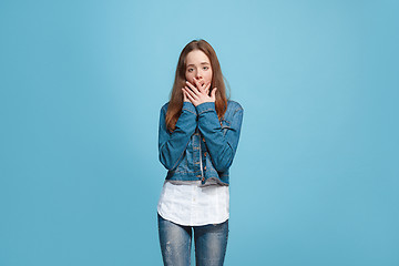 Image showing Beautiful teen girl looking suprised isolated on blue