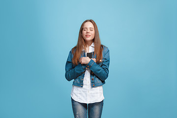 Image showing Beautiful teen girl looking suprised isolated on blue