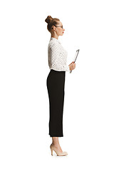 Image showing Full length portrait of a female teacher holding a folder isolated against white background