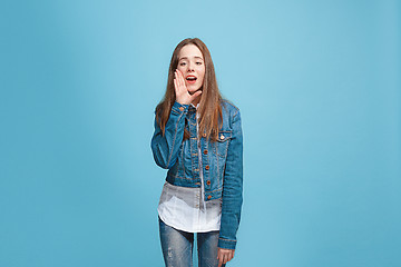 Image showing Isolated on pink young casual teen girl shouting at studio