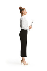 Image showing Full length portrait of a female teacher holding a folder isolated against white background