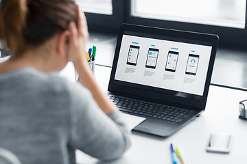 Image showing stressed designer with user interface on laptop