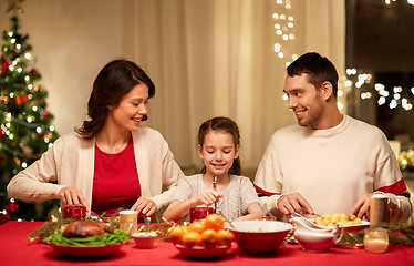 Image showing happy family having christmas dinner at home