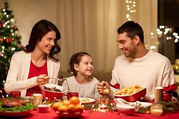 Image showing happy family having christmas dinner at home