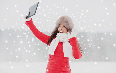 Image showing woman in winter fur hat with tablet pc outdoors