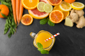 Image showing mason jar glass of fruit juice on slate table top