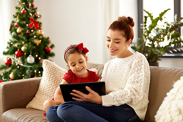 Image showing mother and daughter with tablet pc on christmas