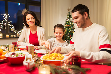 Image showing happy family having christmas dinner at home