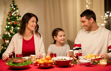 Image showing happy family having christmas dinner at home