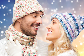 Image showing close up of couple in winter clothes over snow