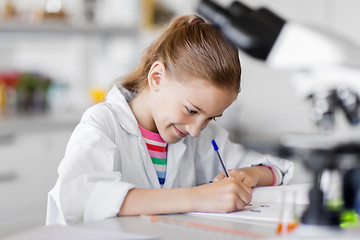 Image showing girl studying chemistry at school laboratory