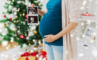 Image showing pregnant woman with ultrasound images at christmas