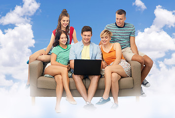 Image showing friends with laptop computer sitting over sky