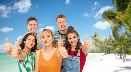 Image showing friends showing thumbs up over tropical beach