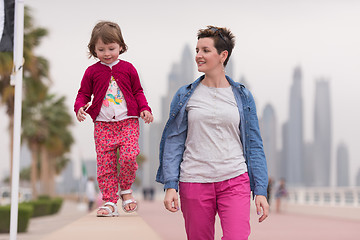 Image showing mother and cute little girl on the promenade