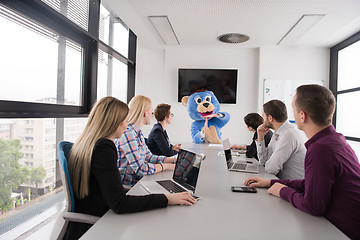 Image showing boss dresed as bear having fun with business people in trendy of