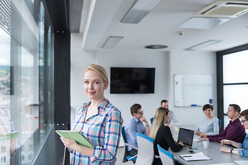 Image showing Pretty Businesswoman Using Tablet In Office Building by window