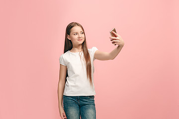 Image showing The happy teen girl making selfie photo by mobile phone