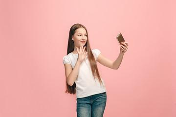 Image showing The happy teen girl making selfie photo by mobile phone