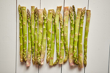 Image showing Above view of flat-lay organic raw uncooked green asparagus