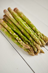 Image showing Above view of flat-lay organic raw uncooked green asparagus