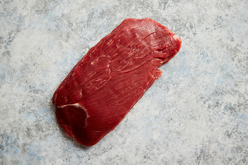 Image showing Piece of raw fresh beef steak placed on gray stone background