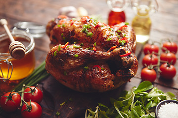 Image showing Roasted whole chicken or turkey served with chilli pepers and chive