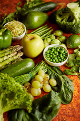 Image showing Fresh green vegetables and fruits assortment placed on a rusty metal