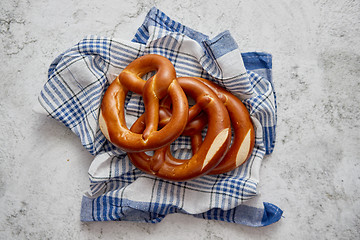 Image showing Three german fresh baked pretzel buns placed on napkin