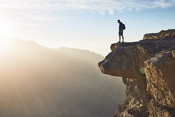 Image showing Tourist on the edge of cliff