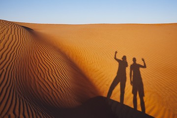 Image showing Shadows of two friends on sand dune