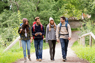 Image showing friends or travelers with backpacks and tablet pc