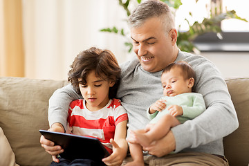 Image showing happy father with preteen and baby son at home