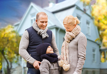 Image showing happy family over living house in autumn