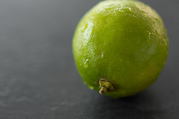 Image showing close up of whole lime on slate table top